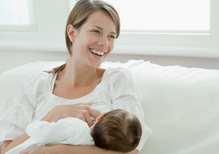 smiling woman breastfeeding