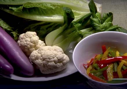a plate and bowl of fresh vegetables